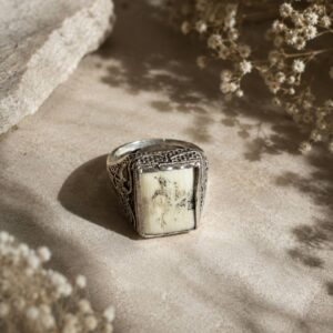 Featuring intricate silver detailing and a stunning natural white real stone