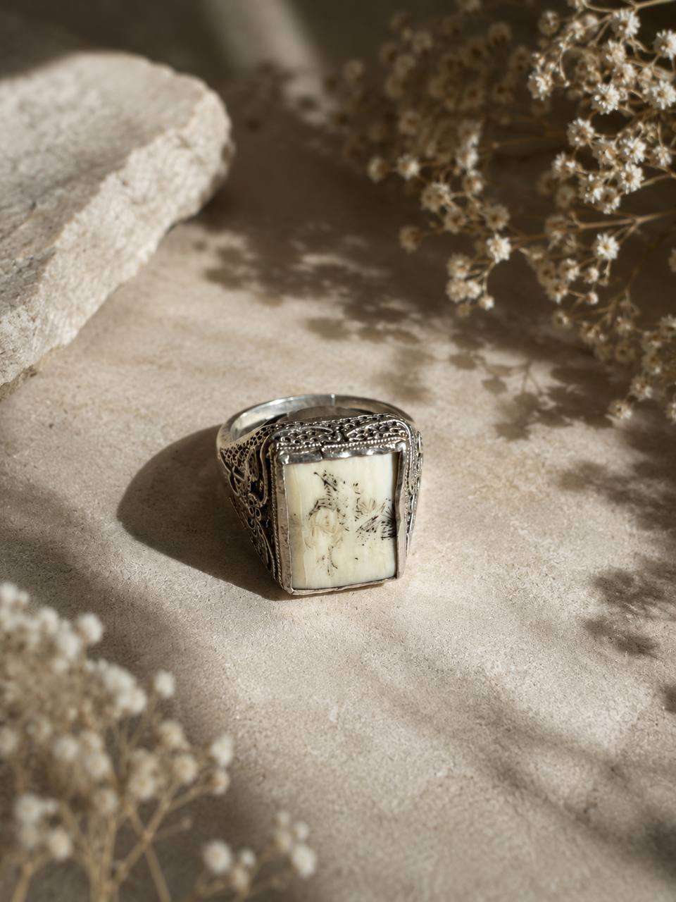 Featuring intricate silver detailing and a stunning natural white real stone